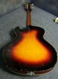 Guild T-100 1963 sunburst w-newer Guild case bottom rear.jpg